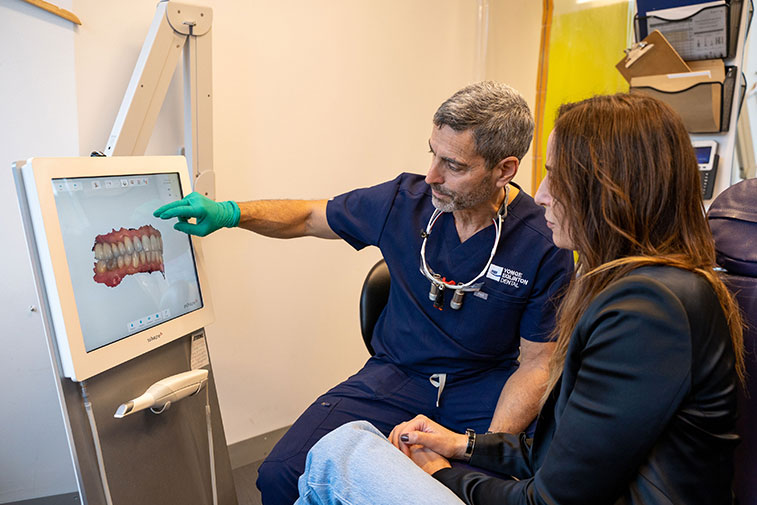 Dentist showing misaligned teeth to a patient
