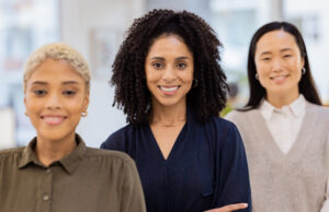 Confident, diverse group of professional women smiling brightly