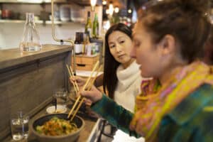 Two women enjoying a healthy lunch at a restaurant near Yonge and Eglinton in Midtown Toronto