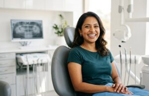 Woman smiling brightly in a dental chair at a Toronto dental office