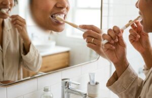 Woman brushing her teeth as part of a daily oral hygiene routine for diabetes care