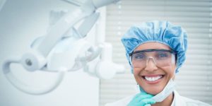 Dental Hygienist smiling photo, wearing disposable kit