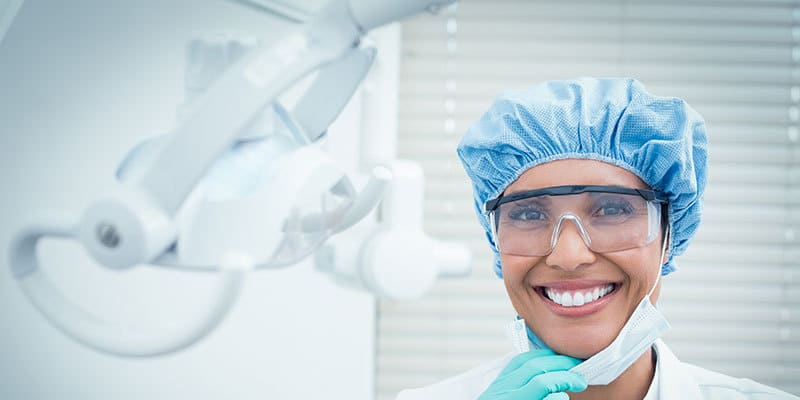 Dental Hygienist smiling photo, wearing disposable kit