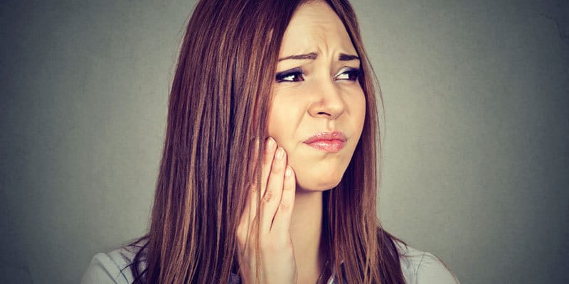 Woman with sore wisdom teeth